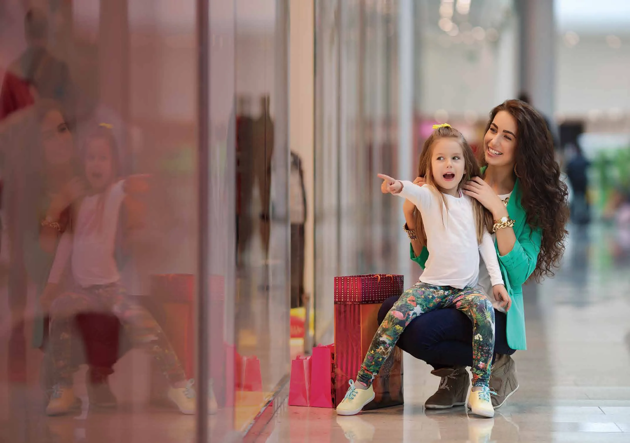 Woman and child beside a shop window. Illustrative lifestyle photograph. Not photographed at the project.