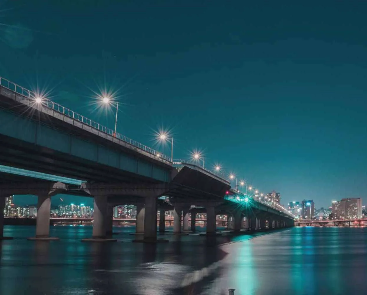Illuminated bridge at night. Illustrative photograph. Location unverified; not evidence of this project or its surroundings.